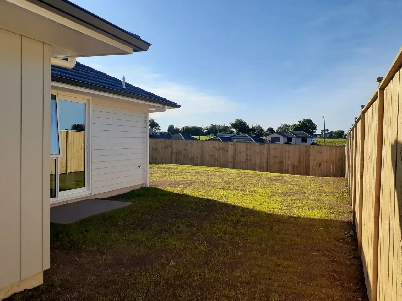 The back yard in 2019: bare lawn, new fences, and no garden beds yet