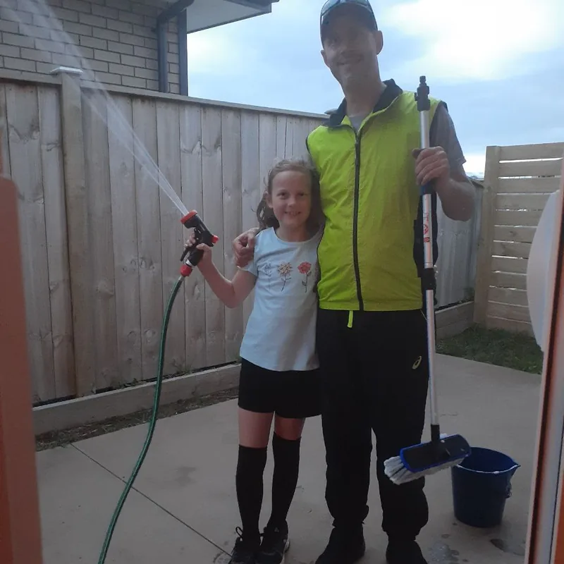 The pair of us on window washing day in 2021, her holding the hose going full bore and me holding the squeegee