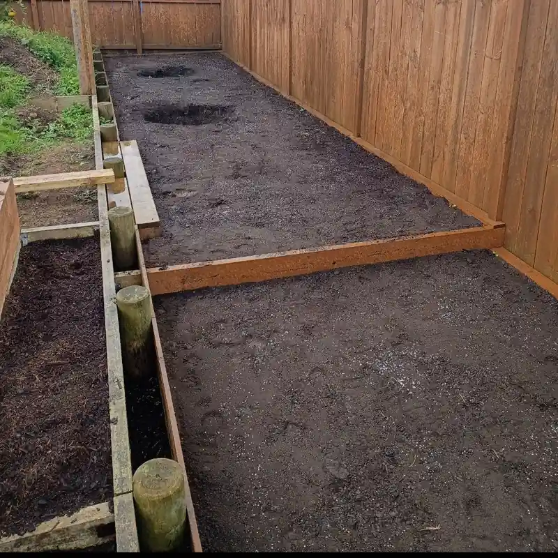 The bed down the back with two dark circles where the pre-dug holes have been filled back in