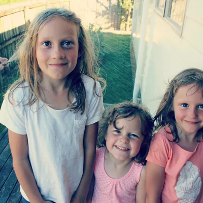 The three girls on the deck, soaked and grinning